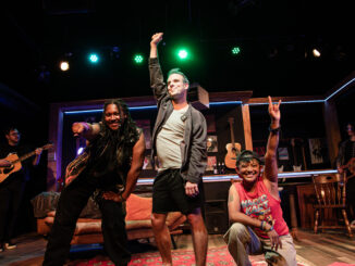 Three people pose at the end of a musical number